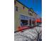 Bright and cheerful retail building with outdoor seating creating a welcoming atmosphere at 1668 Holeman Dr, Erie, CO 80516