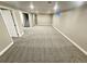 Large basement with neutral carpeting, a staircase and a small window for light at 6717 Lee St, Arvada, CO 80004