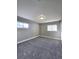 Cozy bedroom featuring neutral walls, plush carpet, and two windows at 6717 Lee St, Arvada, CO 80004