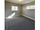 Bright bedroom featuring neutral walls, plush carpet and two windows at 6717 Lee St, Arvada, CO 80004