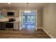 Dining room with chandelier that is open to the kitchen and sunroom, featuring hardwood floors at 6717 Lee St, Arvada, CO 80004