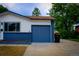 Exterior view of a home highlighting its garage, siding, and landscaping at 6717 Lee St, Arvada, CO 80004