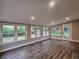 Sunroom with hardwood floors and multiple windows offering lots of natural light at 6717 Lee St, Arvada, CO 80004