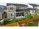 Back exterior of home with covered patio and a fenced yard with garden beds at 15033 Delhi Ave, Parker, CO 80134