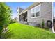 Well-manicured backyard with a covered patio, green lawn, and privacy fence at 15033 Delhi Ave, Parker, CO 80134