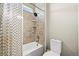 Cozy bathroom with tub-shower combo, tiled walls, and bright lighting at 15033 Delhi Ave, Parker, CO 80134