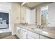 Elegant bathroom with double vanity, granite countertops, and a view of the connecting bedrooms at 15033 Delhi Ave, Parker, CO 80134