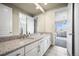 Spacious bathroom with granite countertop, double sinks, and access to an adjacent bedroom at 15033 Delhi Ave, Parker, CO 80134