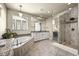 Serene bathroom with soaking tub, glass shower, and elegant finishes, creating a spa-like retreat at 15033 Delhi Ave, Parker, CO 80134