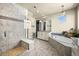 Luxurious bathroom with glass shower, soaking tub, and modern fixtures for a spa-like experience at 15033 Delhi Ave, Parker, CO 80134