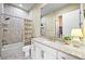 Bright bathroom featuring a tub and shower combination, granite countertop, and a view into the walk-in closet at 15033 Delhi Ave, Parker, CO 80134
