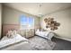 Cozy bedroom featuring two twin beds, a window view, and stylish decor for a comfortable and inviting space at 15033 Delhi Ave, Parker, CO 80134