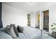 Stylish bedroom with large bed, plush pillows, and nearby closet and bathroom for convenience at 15033 Delhi Ave, Parker, CO 80134