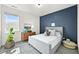 Serene bedroom with natural light, accent wall, and comfortable furnishings, ideal for restful nights at 15033 Delhi Ave, Parker, CO 80134