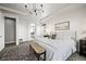 Spacious primary bedroom suite with connecting bath featuring modern decor, chandelier, and natural light at 15033 Delhi Ave, Parker, CO 80134