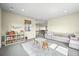 Bright bonus room with comfortable seating, built-in shelving, and stylish décor at 15033 Delhi Ave, Parker, CO 80134