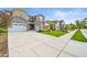 Charming house showcasing a wide driveway, lush green lawn, and a mix of stone and stucco exterior accents at 15033 Delhi Ave, Parker, CO 80134