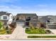Beautiful two-story home boasting a large driveway, well-manicured lawn, and attractive stone and stucco facade at 15033 Delhi Ave, Parker, CO 80134
