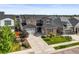 Beautiful two-story home boasting a large driveway, well-manicured lawn, and attractive stone and stucco facade at 15033 Delhi Ave, Parker, CO 80134