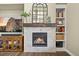 Close-up of a modern fireplace with a decorative mantel, built-in shelving, and a mounted television at 15033 Delhi Ave, Parker, CO 80134