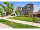 Attractive home with a stone facade, green lawn and landscaped front yard at 15033 Delhi Ave, Parker, CO 80134