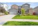 Charming two-story home featuring a stone facade and well-manicured front lawn at 15033 Delhi Ave, Parker, CO 80134