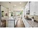 Spacious kitchen features an island with seating, granite counters, and stainless steel appliances at 15033 Delhi Ave, Parker, CO 80134