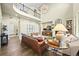 Elegant living room featuring soaring ceilings, a cozy fireplace, and comfortable seating, perfect for relaxation at 15033 Delhi Ave, Parker, CO 80134