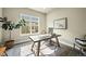 Bright home office with a large window, modern desk, and comfortable seating, perfect for remote work at 15033 Delhi Ave, Parker, CO 80134