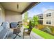 Covered patio includes a grill, outdoor seating, and a view of the yard at 15033 Delhi Ave, Parker, CO 80134