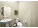 Modern powder room with a pedestal sink and decorative mirror at 15033 Delhi Ave, Parker, CO 80134