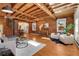 Stunning living room features exposed brick walls, wood-beamed ceilings, and a modern spiral staircase at 1125 E Kentucky Ave, Denver, CO 80209