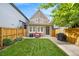 Beautiful backyard featuring green grass, privacy fence, and an outdoor seating area at 1832 W 36Th Ave, Denver, CO 80211