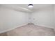 Bright basement space with neutral tile flooring, base trim, and white painted walls at 1832 W 36Th Ave, Denver, CO 80211