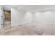 Spacious basement featuring neutral tile flooring and easy access to the full bathroom at 1832 W 36Th Ave, Denver, CO 80211