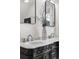 Marble countertop bathroom with double sinks, modern faucet fixtures, and vintage-inspired black vanity at 1832 W 36Th Ave, Denver, CO 80211