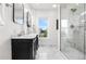 This primary bath offers double sinks with a marble countertop and marble shower with glass door enclosure at 1832 W 36Th Ave, Denver, CO 80211