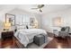 Bright bedroom with dark floors, white walls, ceiling fan, and charming decor provides a cozy and inviting retreat at 1832 W 36Th Ave, Denver, CO 80211