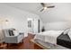Well-lit bedroom boasts hardwood floors, a ceiling fan, and a cozy reading nook with natural light at 1832 W 36Th Ave, Denver, CO 80211