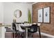 Modern dining room with brick accent wall, stylish decor, and ample seating at 1832 W 36Th Ave, Denver, CO 80211