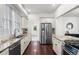 Bright kitchen featuring stainless steel appliances, granite counters, and white cabinetry at 1832 W 36Th Ave, Denver, CO 80211