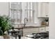Kitchen with granite counters, stainless steel sink, and modern fixtures under a window at 1832 W 36Th Ave, Denver, CO 80211