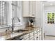 The kitchen features granite countertops, a stainless steel sink and appliances, and white cabinetry at 1832 W 36Th Ave, Denver, CO 80211