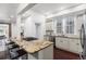 Kitchen island with granite countertop, stainless steel dishwasher, and gas cooktop for cooking at 1832 W 36Th Ave, Denver, CO 80211