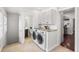 Convenient laundry area features a washer, dryer, granite counter, and storage cabinets at 1832 W 36Th Ave, Denver, CO 80211