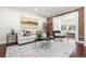 Inviting living room with exposed brick, white sofa, and natural light at 1832 W 36Th Ave, Denver, CO 80211