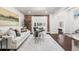 Bright living room boasting exposed brick, hardwood floors, and an open layout at 1832 W 36Th Ave, Denver, CO 80211