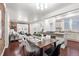 Open floor plan showcasing dining, living, and kitchen areas with brick accents and hardwood flooring at 1832 W 36Th Ave, Denver, CO 80211