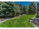 Lush backyard featuring mature trees and impeccable landscaping at 9315 E Aspen Hill Ln, Lone Tree, CO 80124