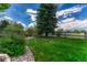 Scenic backyard with lush greenery, trees, and a well-maintained fence at 9315 E Aspen Hill Ln, Lone Tree, CO 80124